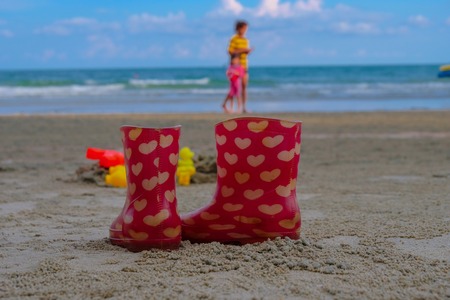 Heart of boots from kid who take off and walking with her mother on long holiday.の写真素材