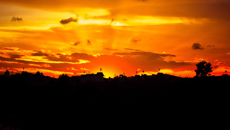 Beautiful silhouette village against with orange sun rise.の写真素材