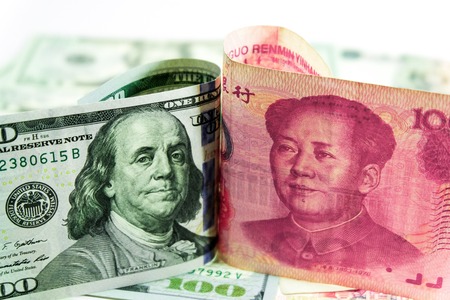 US dollar bill and China yuan banknote . America is debtor of China and now China get balance of trade with USA. so USA will increase tax for goods from China.の写真素材