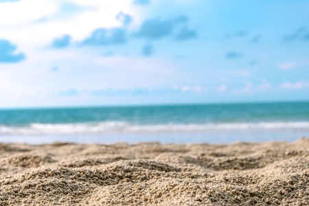 brown warm sand and summer sea with sky and free space for add some merchandise or goods of online advertisement. Copy space and free space concept.の写真素材