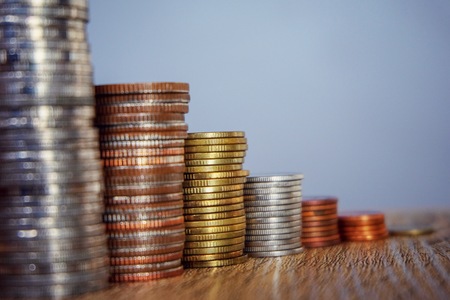 Many coins stacking and growing for saving and earn concept.の写真素材