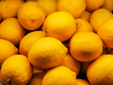Heap of lemon fruit which it orange color. Lemon fruit are high vitamin C fruit which it can prevent flu.の写真素材