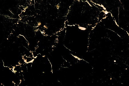 Luxury golden pattern design on black marble which it is used for poster brochure invitation cover book catalog wallpaper and texture.の写真素材