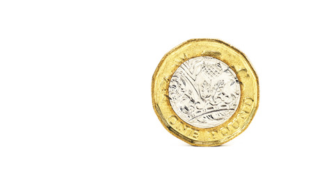 Close up isolated of one pound coin from united kingdom on white backgroundの写真素材