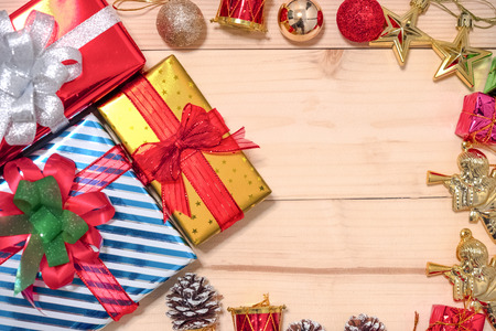 Christmas  and happy new year composition gift and decorations such as red ball  gold star pine cone  gold angel on wooden background. Flat lay , top view , copy space.の写真素材