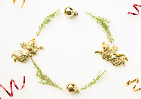 Christmas and Happy new year composition. Wreath from green fir leaf ,gold angel and ribbon on white background. Flat lay, top view, copy space use for template and greeting card.の写真素材