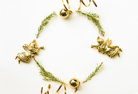 Christmas and Happy new year composition. Wreath from green fir leaf ,gold angel and ribbon on white background. Flat lay, top view, copy space use for template and greeting card.の写真素材