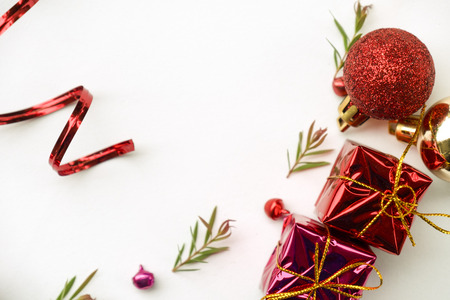 Christmas and Happy new year composition, Christmas present gift boxes,pine cones, fir branches, red ball on wooden white background. Flat lay, top view, copy space.の写真素材