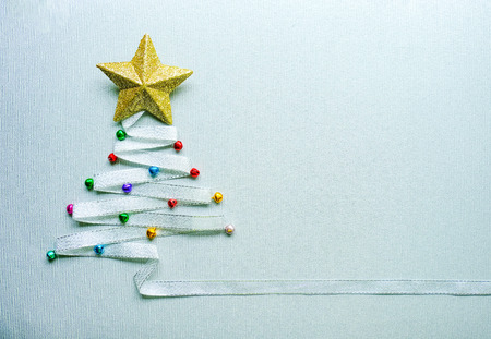 Merry Chistmas tree made from silver ribbon and gold star and small colorful ball on white background. Merry chirstmas and happy new year conceptの写真素材