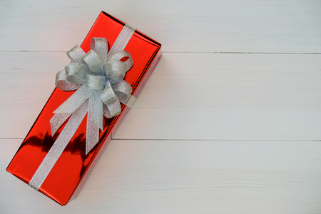 Christmas and Happy new year composition, Christmas  red present gift boxes with silver ribbon on wooden white background. Flat lay, top view, copy space.の写真素材