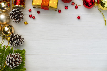 Christmas and Happy new year composition, Christmas present gift boxes,pine cones, fir branches, red ball on wooden white background. Flat lay, top view, copy space.の写真素材