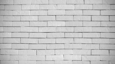 Abstract weathered modern white bricks wall background stucco in rural room . The brick work from stone tile which its was from modern paint technology.の写真素材