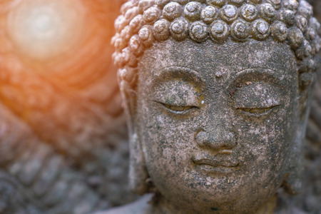 Rock Buddha statue with sunlight used for amulets of Buddhism religion. Buddhism is popular region in China Japan and south east Asia.copy space concept.の写真素材