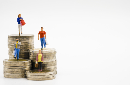Miniature of shopping women and men on coins stacking with white background. Shopping and copy space concept - Image Miniature of shopping women and men on coins stacking with white background. Shopping and copy space concept - Image