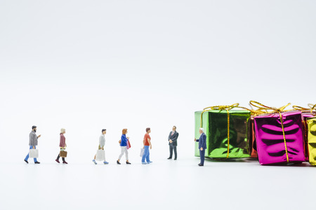 Miniature shopper : Men and women hand carry shopping bag and walk on white background. Buy and sale  items using as shopping business concept.-Image.の写真素材