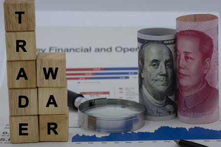 Trade war wording on wooden cubes with USA and China banknotes.Its is symbol for tariff trade war crisis or unfair business of 2 biggest economic countries in the world.の写真素材