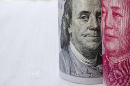 US dollar and China Yuan banknote  on white background. Its is symbol for tariff trade war crisis or unfair business of 2 biggest economic countries in the world.の写真素材