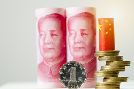 China Yuan banknote with coin stacking and China flag on white background.Yuan is main exchange money in the world.-Image. - Imageの写真素材