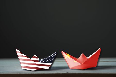 USA flag and China flag print screen on ship with black background.It is symbol of tariff trade war tax barrier between United States of America and China.-Image.の写真素材