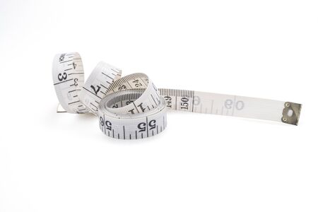 Closeup of measuring tape on white background. Isolated with clipping path photo.