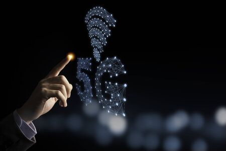 Businessman hand pointing blue 5G and signal infographic with black background and bokeh.5...