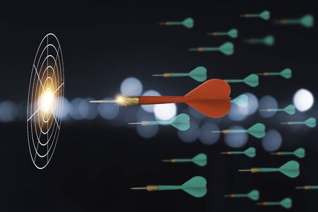 Closeup of Red dart among green arrow darts shooting to one target board . It is symbol of business investment competition to achieve goal and target.の写真素材