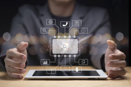 Businessman hand create artificial intelligence for technology transformation and internet of thing on tablet. Cloud technology will management big data include business strategy , customer service.の写真素材