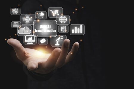 Hand holding digital transformation  with technology icons such as laptop computer graph.Cloud technology management big data include business strategy , customer service.の写真素材