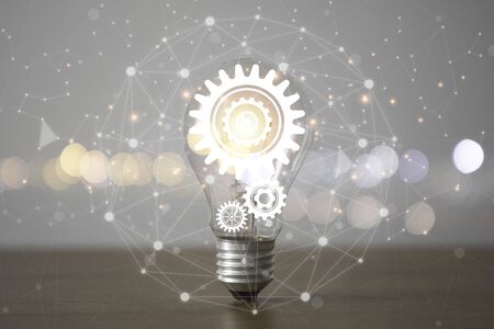 Lightbulb with cog gears and connection line. Creative thinking idea concept.の写真素材