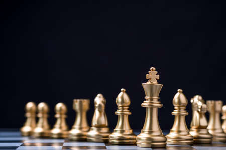 Golden king chess stand in front of others chess pieces. Leadership business teamwork and marketing strategy planing concept.の写真素材