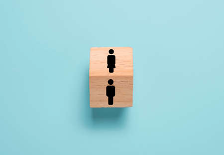 Opposite of man and woman icon on wooden block cube. Man and woman quite different thinking and...