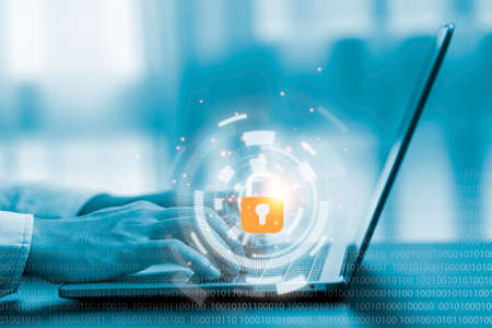 Hand using computer laptop by input password to login and access to computer system. Security in...