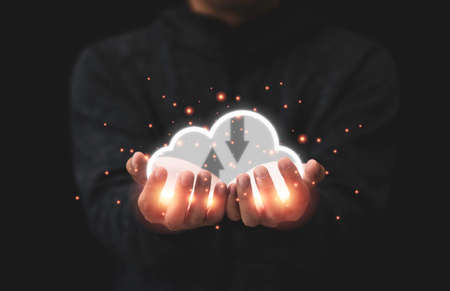 Businessman holding virtual cloud computer for upload and download marketing data information.Cloud...