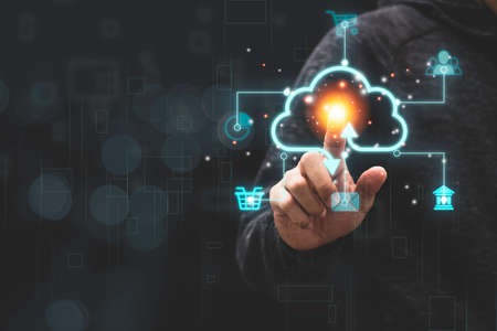 Businessman touching virtual cloud computing with icon to transfer data information and upload download application. Technology transformation concept.の写真素材