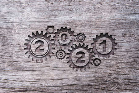 2021 year with gear cog carved old wood.Merry Christmas and happy new year concept.の写真素材