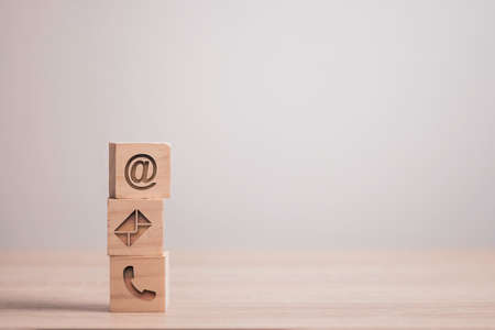 Sign of e-mail , address and telephone carved on wooden block cube for business marketing contact website page.の写真素材