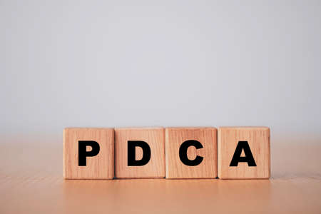 Plan do check action concept , PDCA printed screen on wooden cube block.の写真素材