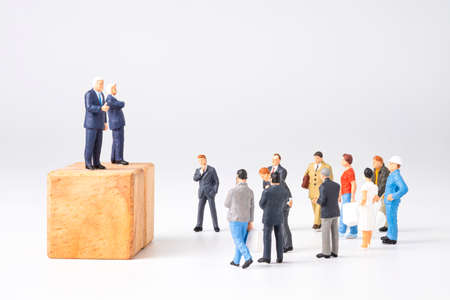Democracy and Election of President and Prime Minister concept , Two Politicians miniature figures make an announcement the public listen to the policy economy and health care.の写真素材