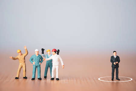 Different thinking and leadership concept , Miniature figure manager separate from staff workers.の写真素材
