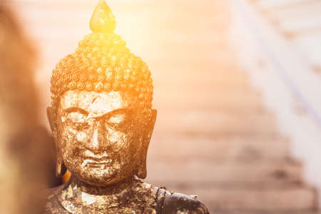 Golden Buddha statue with sunlight used for amulets of Buddhism religion. Buddhism is popular region in China Japan and south east Asia.copy space concept.の写真素材