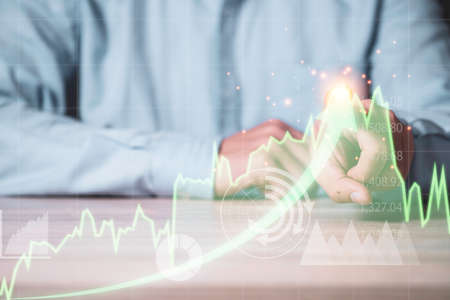 Businessman touching on top of green technical stock investment graph with increase arrow. Value...