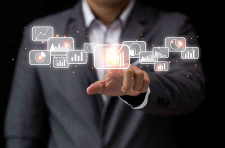 Businessman pointing and touching virtual data graph analysis. Big data and information management...