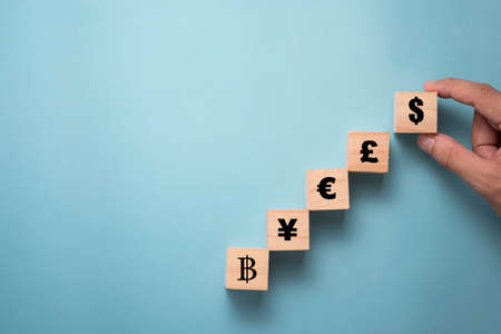 Multi currency sign symbols print screen on wooden cubes block and connection.Exchange currency and...