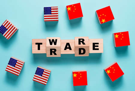Trade war wording on wooden cubes block with USA and China flag.It is symbol of economic tariffs trade war and tax barrier between United States of America and China.の写真素材