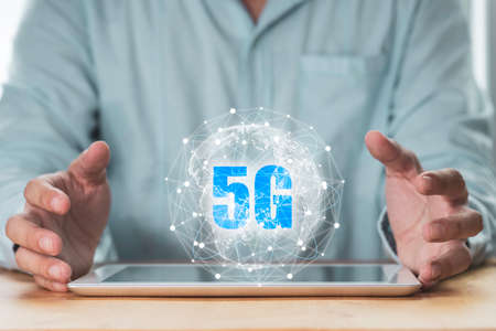 5G and internet of thing or IOT concept , Businessman protecting virtual 5G global networking on...