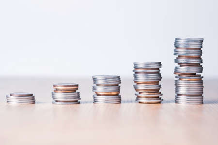 Stock market investment and business profit concept, Increasing Silver and bronze coins stacking chart on table.の写真素材