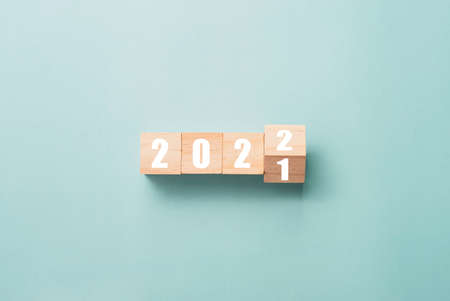 Merry Christmas and happy new year concept, Flipping of wooden cube block change from 2021 to 2022.の写真素材