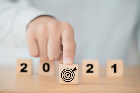 Businessman pushing target board  in front 2021 year for start new year business plan.