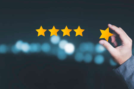 Customer satisfaction and product service evaluation concept , Hand holding and put yellow star to...