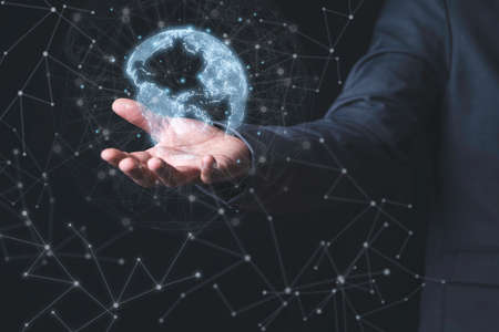 Businessman holding virtual world with connection line for global networks and technology linkage concept.の写真素材